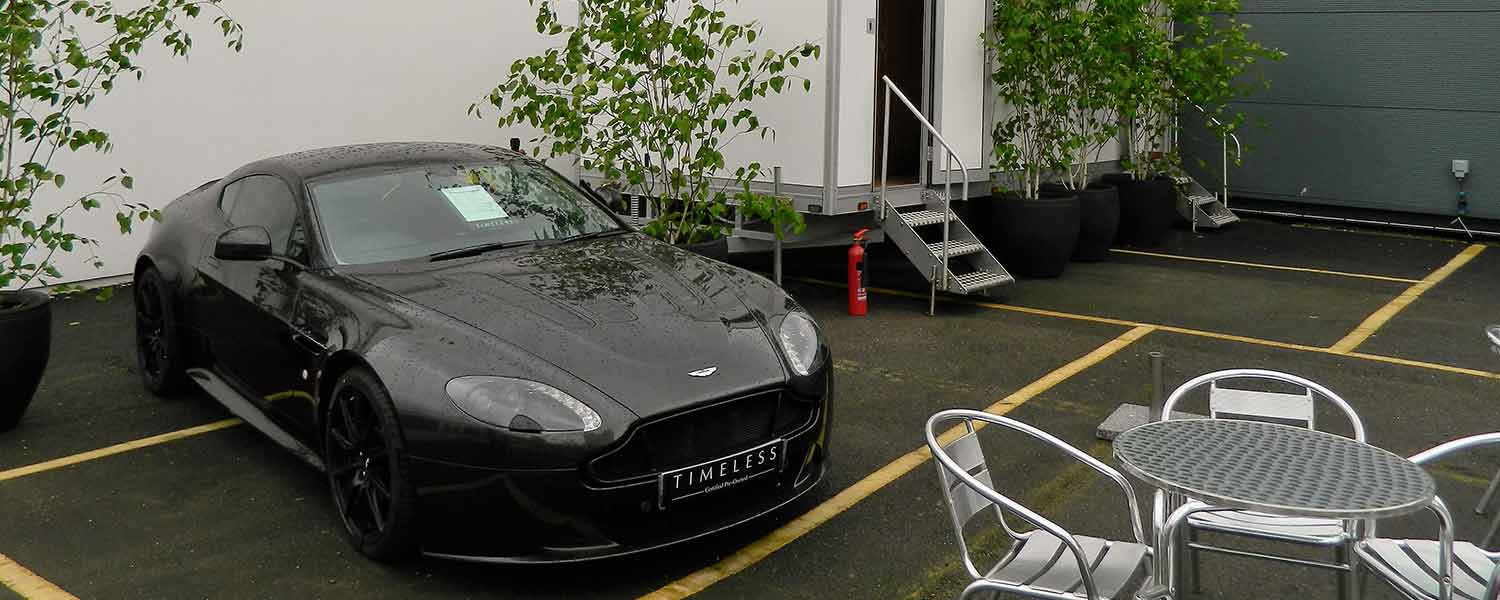 Any occasion toilet hire with black sports car outside